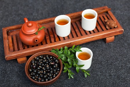 Traditional Chinese tea ceremony with black currant, fruit tea and healthy food. Photo without people. Summer natural vitamins and berries.の写真素材