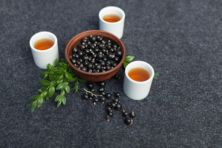 Traditional Chinese tea ceremony with black currant, fruit tea and healthy food. Photo without people. Summer natural vitamins and berries.の写真素材