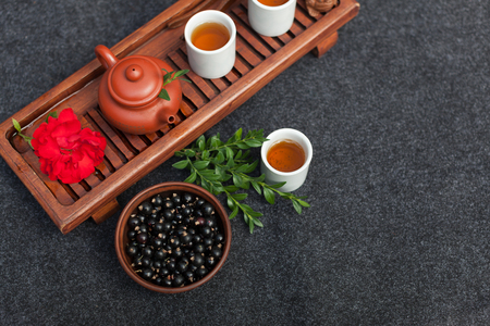 Traditional Chinese tea ceremony with black currant, fruit tea and healthy food. Photo without people. Summer natural vitamins and berries.の写真素材