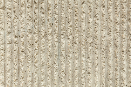 Surface of the wall with a decorative white plaster. Textured concrete wall with vertical lines and stripes as a texture or background. Repair, design conceptの写真素材