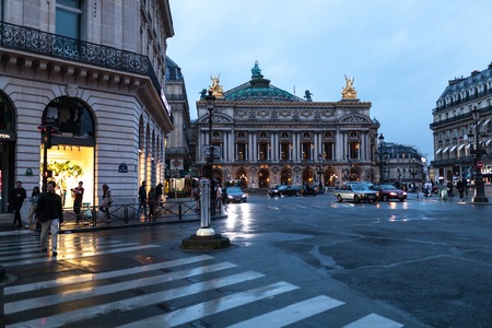 Paris, France 01 June 2018 Traffic cars in front of Opera, Paris. The Palais Garnier is a 1,979-seat opera house, which was built from 1861 to 1875 for the Paris Opera.のeditorial素材