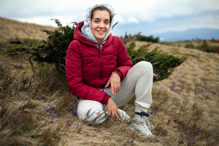 A woman travels to the mountains field Autumn or Spring Seasonの写真素材