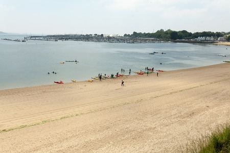 Brest, France 28 May 2018 Adventurous children learning to paddle on stand up board. Happy teenage having fun enjoying adventurous experience on the ocean on a sunny day during summer holidaysのeditorial素材