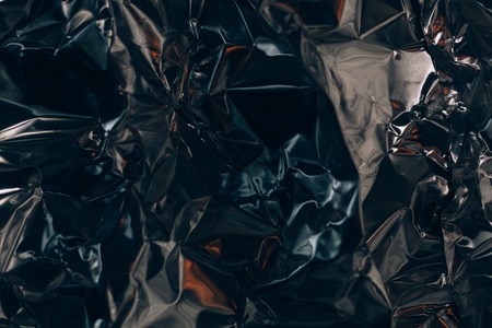 Full frame take of a sheeT of crumpled silver aluminum foil backgroundの写真素材