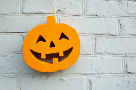 Halloween pumpkin on the white-coloured wallの写真素材