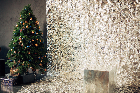 christmas tree with colorful balls and gift boxes over white silver background with many copy space for your textの写真素材