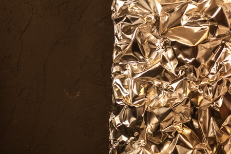 Full frame take of a sheeT of crumpled silver aluminum foil backgroundの写真素材