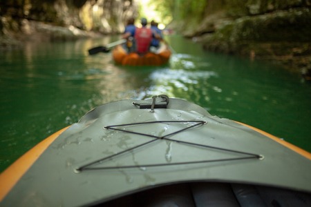 Kayaking on the river. group of people in a boat sailing along the river. Rowers with oars in a canoe. Rafting on a kayak. Leisureの写真素材