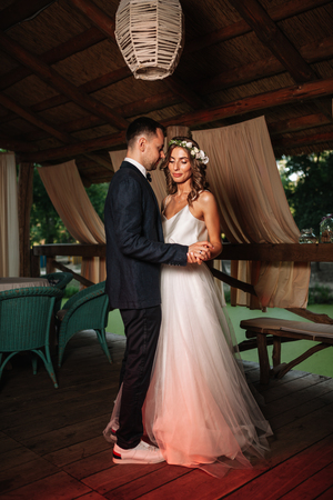 Happy bride and groom and their first dance, wedding in the elegant restaurant with a wonderful light and atmosphere.の写真素材