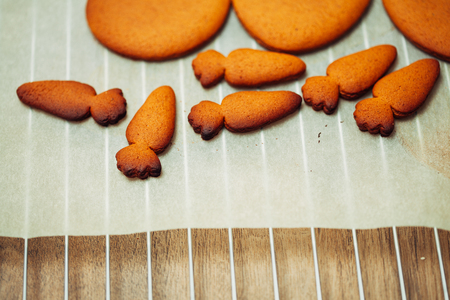 cooking and home concept - close up of female hands making cookies from fresh dough at homeの写真素材