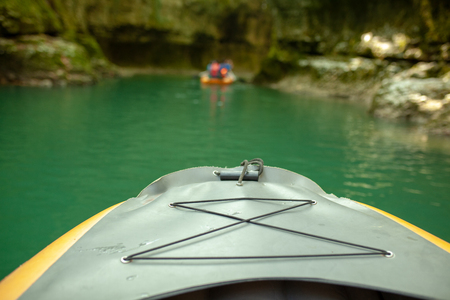 Kayaking on the river. group of people in a boat sailing along the river. Rowers with oars in a canoe. Rafting on a kayak. Leisureの写真素材