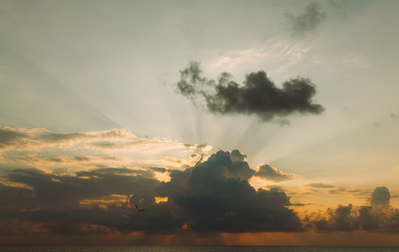 Fantastic sky, dramatic sunset, beautiful natural background. Setting sun illuminates the cloudsの写真素材