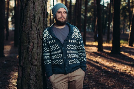 Outdoor portrait of handsome bearded man . Casual autumn fashion portrait Hipster in the forestの写真素材