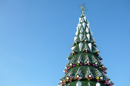 City Christmas tree against a blue sky. Christmas Garlands. Weekends and holidays.の写真素材