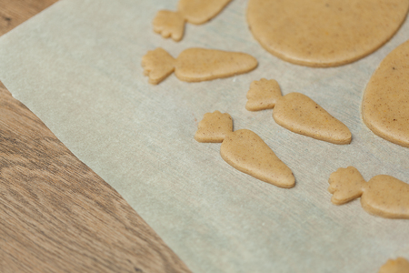 cooking and home concept - close up of female hands making cookies from fresh dough at homeの写真素材