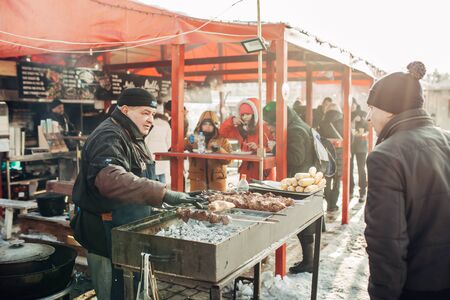 Ukraine, Kharkov 30 December 2018 Christmas market. New Year's Fair. Winter street food. Holidays and weekends in the city. Family Leisure.のeditorial素材