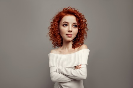 Funny red curly girl with big head and funny hairstyle. Caricature stylization of female logic. Young blogger. female psychologyの写真素材