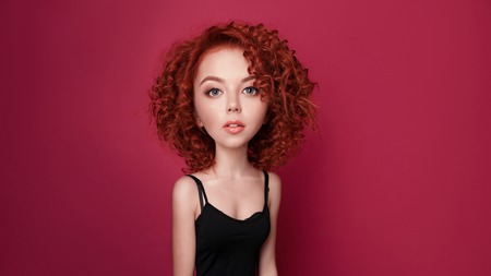 Funny red curly girl with big head and funny hairstyle. Caricature stylization of female logic. Young blogger. female psychologyの写真素材