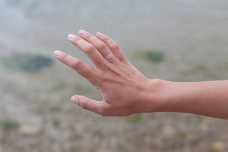 Hand without engagement ring with suntan. The girl took off the wedding ring on vacation that no one knew that she was married.の写真素材