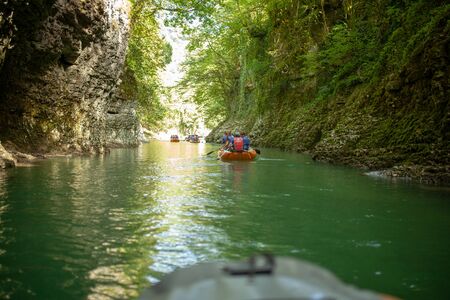 Martvili, Georgia September 2018 People on an excursion between rocks in inflatable boats along the canyon.のeditorial素材