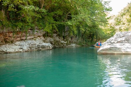 Martvili, Georgia September 2018 People on an excursion between rocks in inflatable boats along the canyon.のeditorial素材