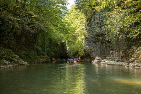 Martvili, Georgia September 2018 People on an excursion between rocks in inflatable boats along the canyon.のeditorial素材