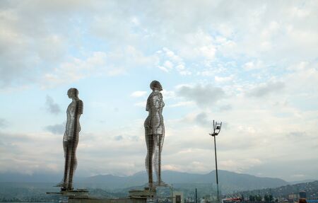 Batumi, Georgia - August, 2018: A moving metal sculpture titled Man and Woman or Ali and Nino with cloud sky on the backgroundのeditorial素材