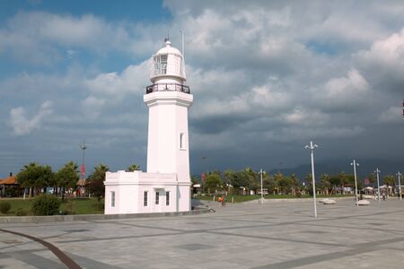 Batumi, Georgia - 29 August 2018: White Lighthouse with cloud sky on the background.のeditorial素材