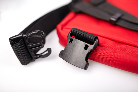Black side release acculoc buckle plastic clasp, quick nylon belt rope lock strap, isolated macro closeup, large detailed horizontal accessory studio shotの写真素材