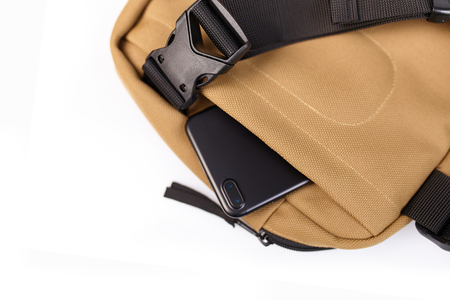 Beige bag on a white isolated background with a hidden pocket for a mobile phone close upの写真素材