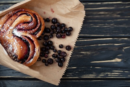 Rustic with black current berry filling pie on black wooden table background. Tasty breakfast. Bakery Fresh Healthy breakfast. Unhealthy food with glutenの写真素材