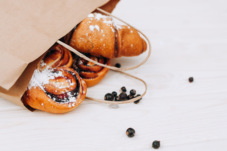 Mock up. Healthy tasty breakfast. Top view, copy space. Bakery on the white Wooden background. French breakfast. Paper package. Breakfast food table.の写真素材