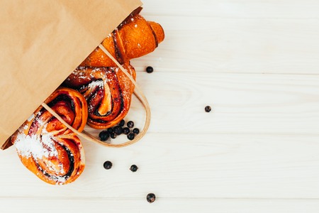 Mock up. Healthy tasty breakfast. Top view, copy space. Bakery on the white Wooden background. French breakfast. Paper package. Breakfast food table.の写真素材