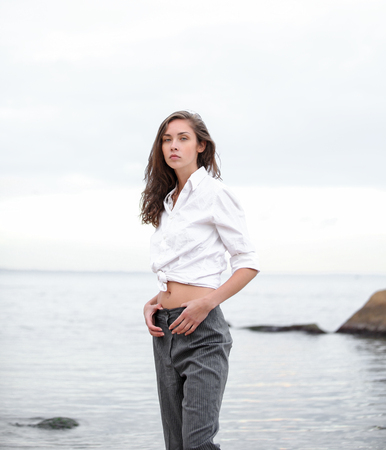 Beautiful caucasian girl have fun on the sea beach at the vacation Summer outdoor leisure Youth lifestyleの写真素材