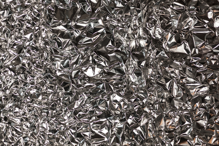 Full frame take of a sheeT of crumpled silver aluminum foil backgroundの写真素材