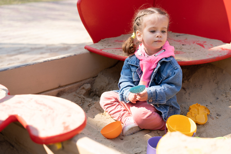 Cute little caucasian girl on the playground, happy child with pleasure spending time outdoors, happy carefree childhood Summer season childrens leisureの写真素材