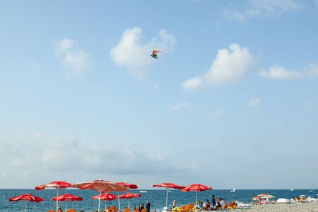 Batumi, Georgia August 2018: Coca Cola Umbrella On The Black Sea Beach with cloud sky on the backgroundのeditorial素材