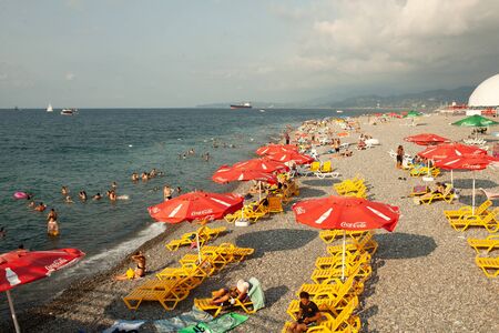 Batumi, Georgia August 2018: Coca Cola Umbrella On The Black Sea Beach with cloud sky on the backgroundのeditorial素材