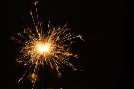 Sparkler background. Christmas and new year sparkler holiday background. bengal light on the black backgroundの写真素材