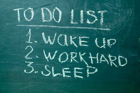 To do list it handwritten with white chalk on a green blackboard.