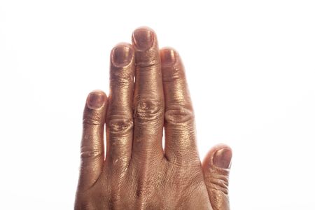Human hand painted gold paint isolated on white background.の写真素材