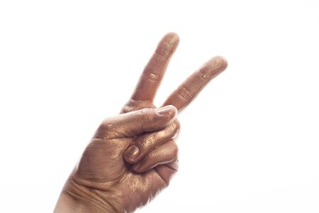 Human hand painted gold paint isolated on white background.の写真素材