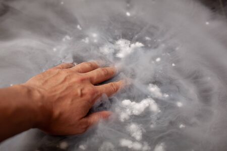 Thick white smoke on a background of black ceramic tiles. Dry ice tobaccoの写真素材