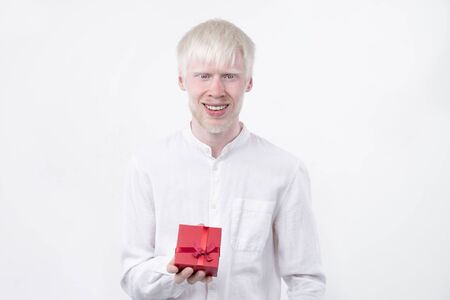 portrait of an albino man in  studio dressed t-shirt isolated on a white background. abnormal deviations. unusual appearance. skin abnormalityの写真素材