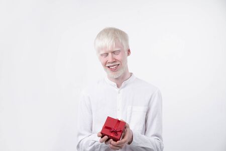 portrait of an albino man in  studio dressed t-shirt isolated on a white background. abnormal...