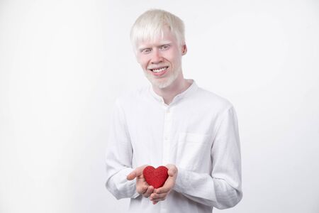 portrait of an albino man in  studio dressed t-shirt isolated on a white background. abnormal deviations. unusual appearance. skin abnormalityの写真素材