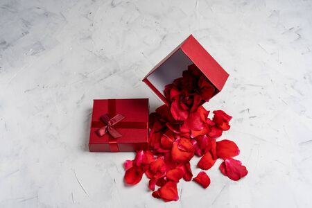 Beautiful red roses next to a gift red box on a white background. New Year Christmas birthday Valentine's Day Mother's Day presentの写真素材