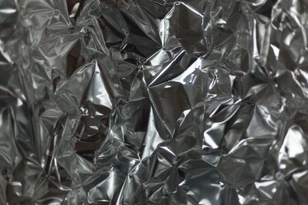 Full frame take of a sheeT of crumpled silver aluminum foil backgroundの写真素材