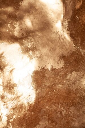 Gold chemical dirty colored water background close up.の写真素材