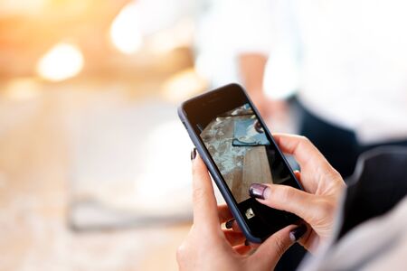 A woman shoots the khachapuri preparation process on the mobile phone. Closeup photo. Space for text. Culinary bloggerの写真素材